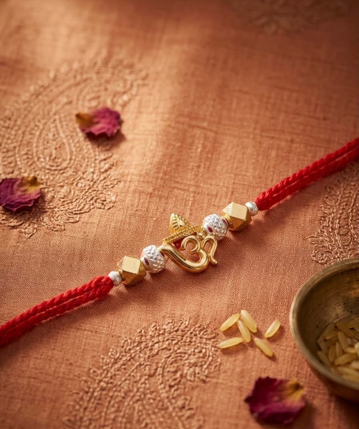Red thread OM Rakhi bracelet with gold-toned OM charm and white bead accents